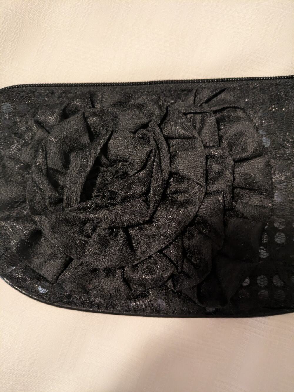 Black Sequin Clutch With Flower. Zip Closure And Inside Zippered Compartment